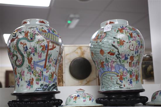 A pair of Chinese famille rose hundred boys baluster jars and covers, 19th century, 42cm, wood stands, one jar cracked